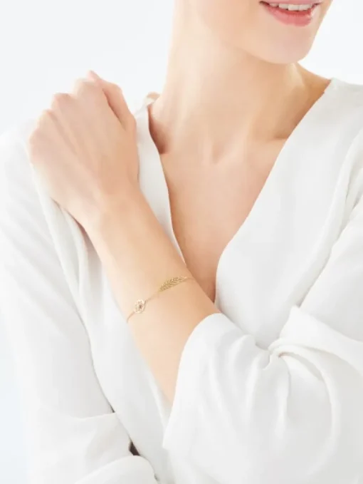Bransoletka z żółtego i białego złota z brylantem - piórko - 0,005 ct - próba 375