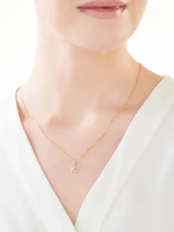 Złota zawieszka z cyrkonią - litera M