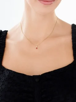 Złota zawieszka z rubinem syntetycznym